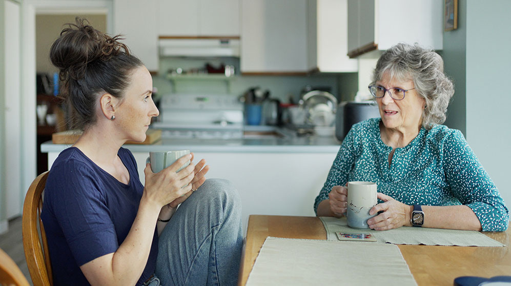 Photo of an older woman and her adult daughter discussing estate planning