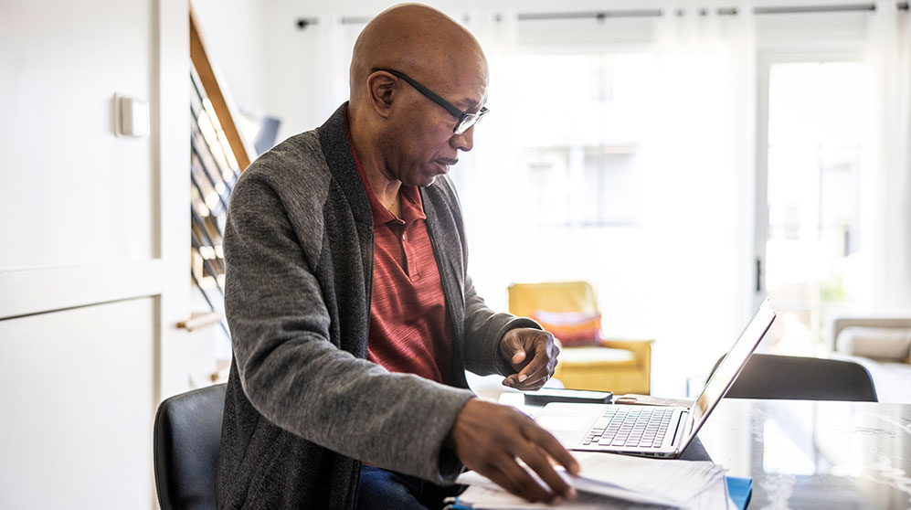 Photo of an older man reviewing his retirement funds